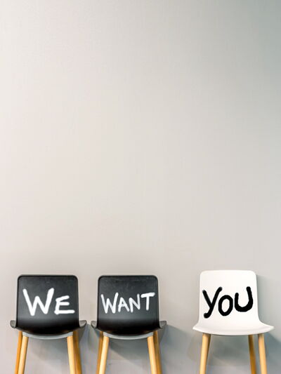 Drei leere Stühle mit der Aufschrift „We want you“ symbolisieren: Wir suchen engagierte Auszubildende, die Teil unseres Teams werden möchten.